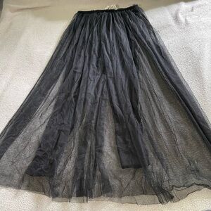 cute black, sheer flowy skirt with black pants underneath.